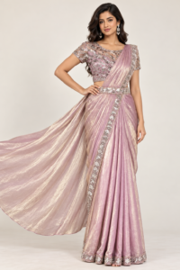 Model wearing a dusty rose ready-to-wear saree with a silver embellished border and matching stitched sequin blouse.