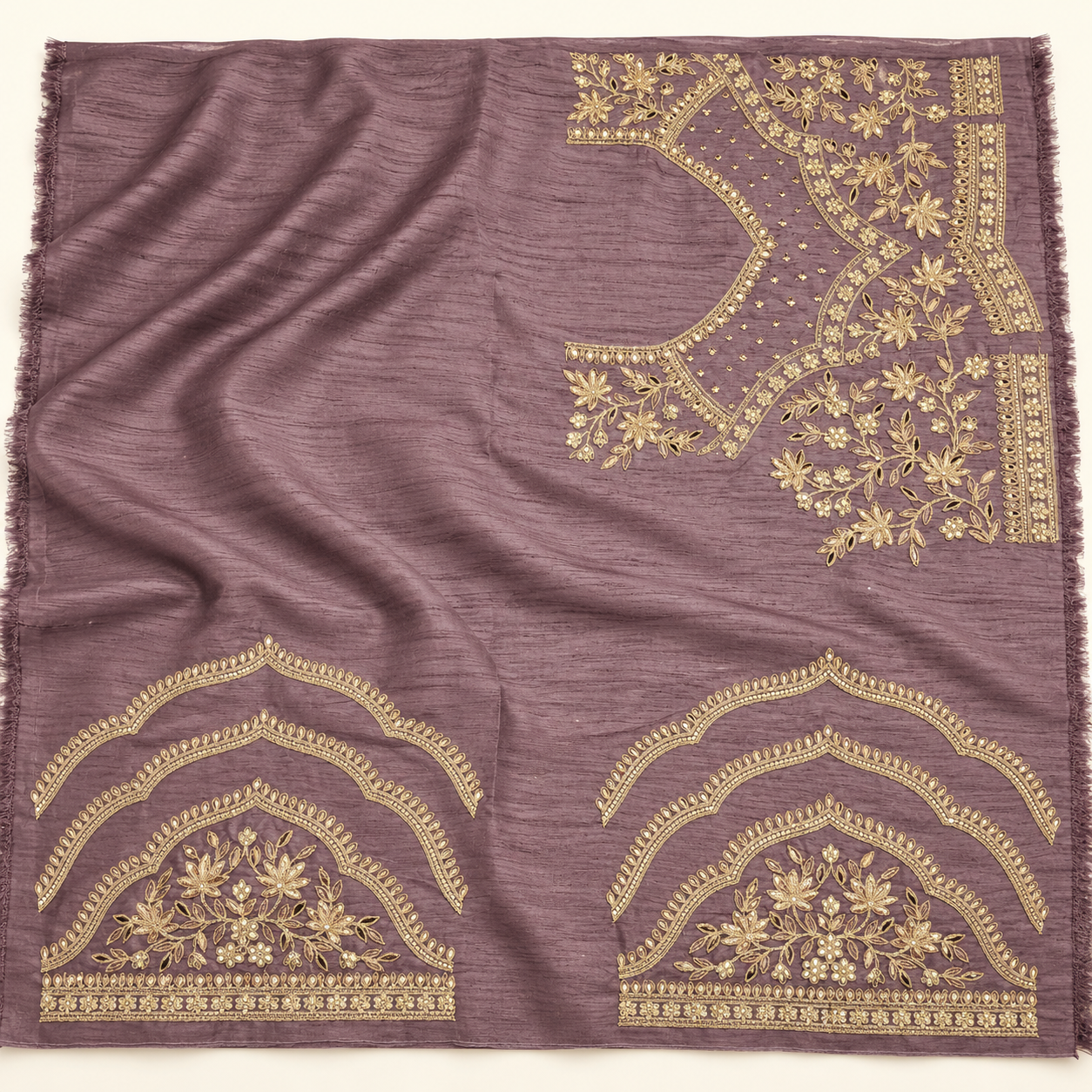 Illustration of plum blouse material with gold floral motifs, small geometric patterns and ornamental bands.