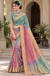 Multicolour ombre organza saree in sea green, dusty pink and lavender with golden zari floral border, displayed on a model.